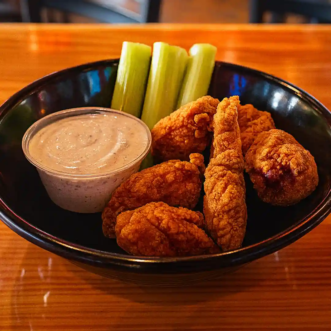 Boneless chicken wings served with celery sticks and dipping sauce at Wilson’s Bar & Grill in Hilliard Ohio