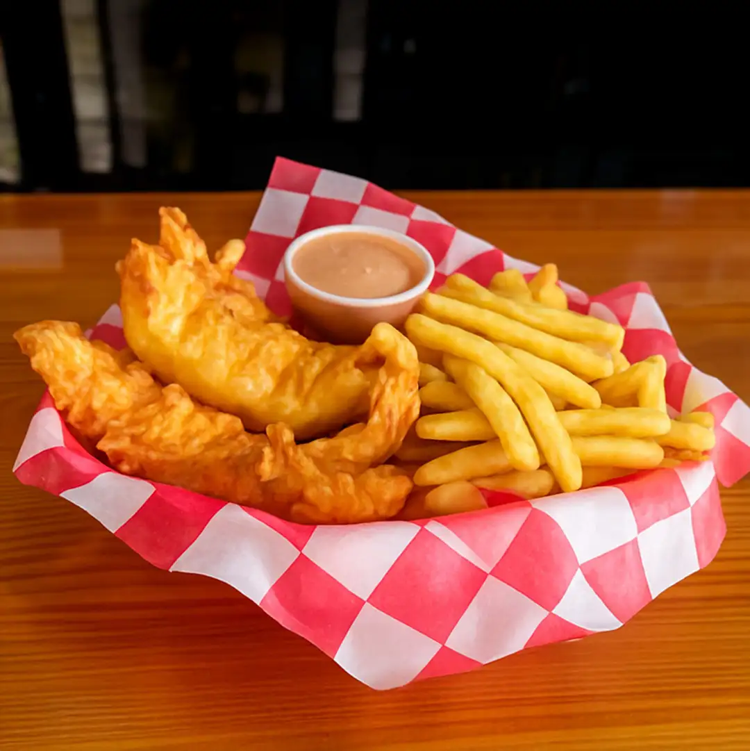 Crispy chicken tenders served with fries and dipping sauce at Wilson’s Bar & Grill in Hilliard Ohio