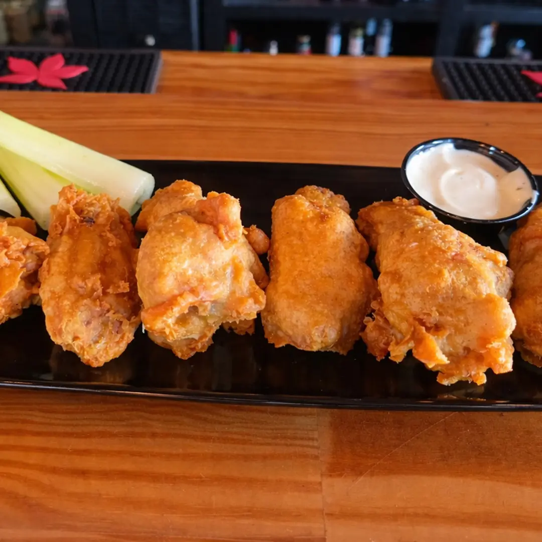Traditional bone-in chicken wings served with celery and dipping sauce at Wilson’s Bar & Grill in Hilliard Ohio