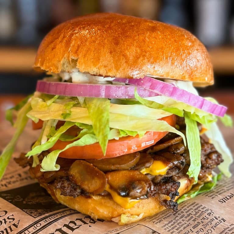 Wilson Smash Burger with American cheese, spicy sautéed mushrooms, lettuce, tomato, onion, and housemade No. 07 Sauce at Wilson’s Bar & Grill in Hilliard, Ohio.