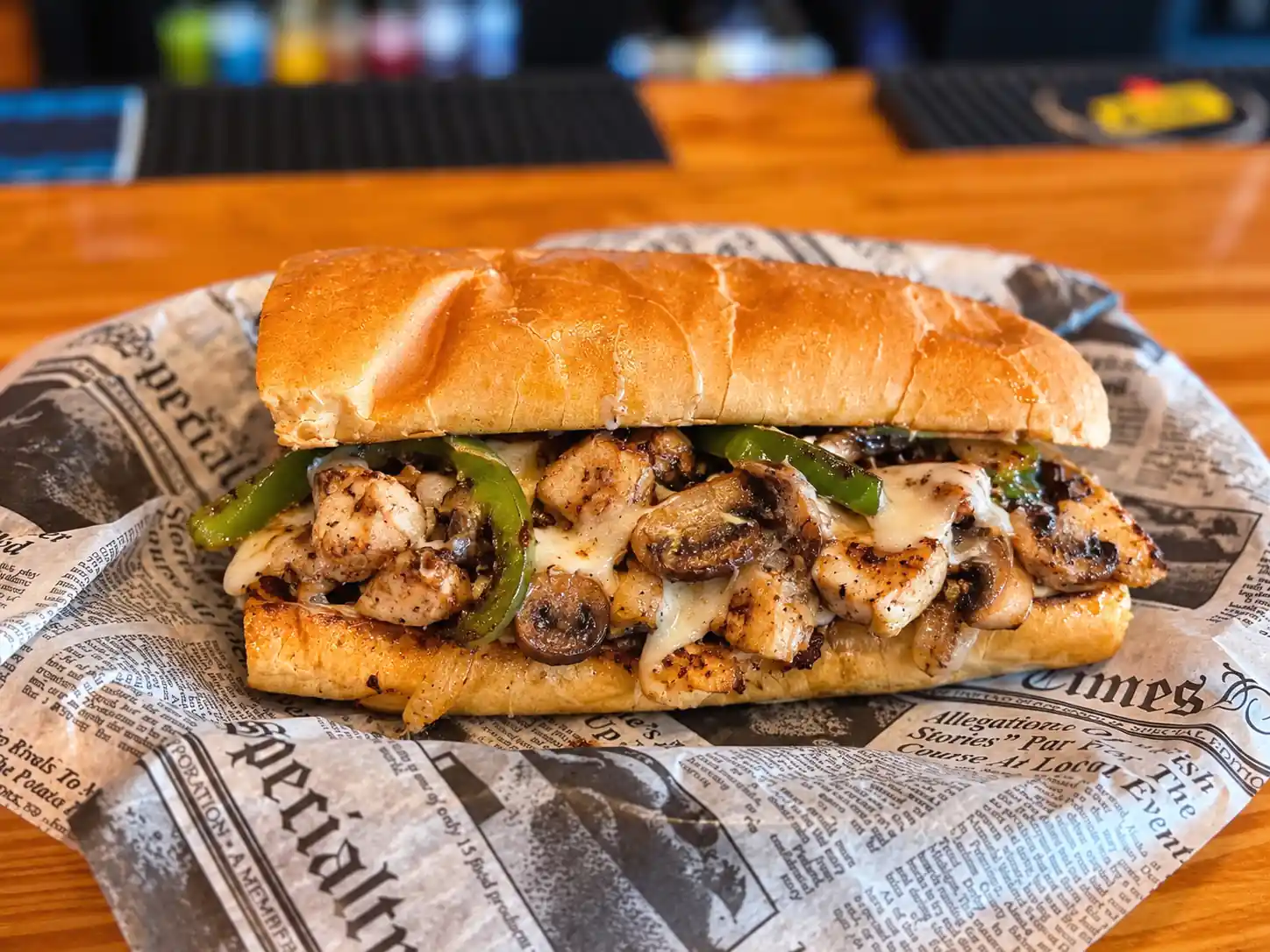 Wilson’s Chicken Philly Cheesesteak with chicken, green peppers, mushrooms, and melted cheese on a toasted roll