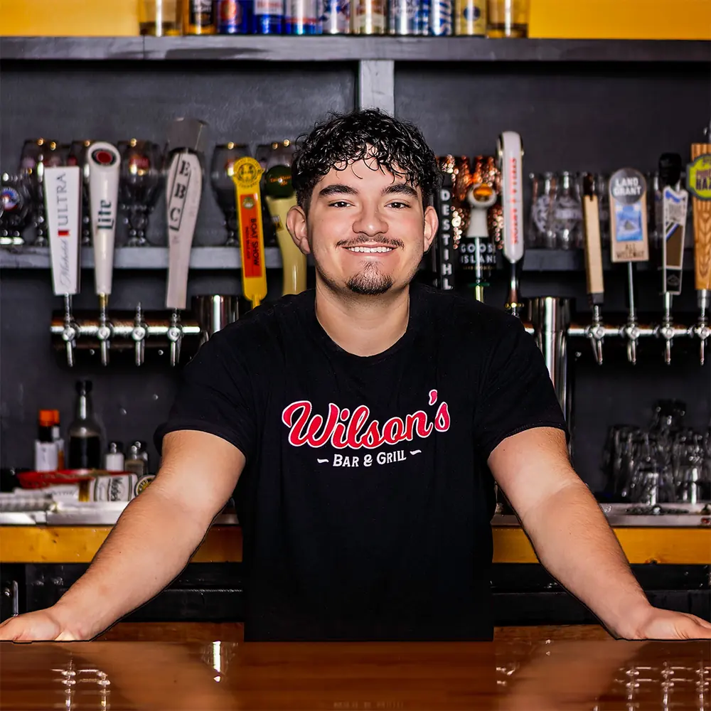 Xavier, owner of Wilson’s Bar & Grill, behind the bar in Hilliard